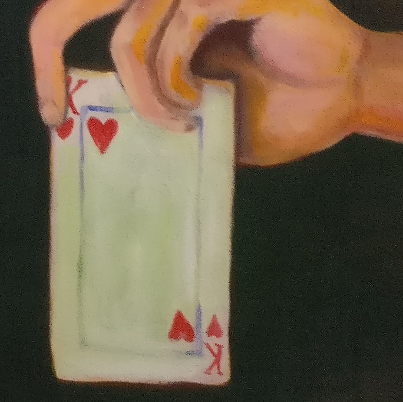 closeup of hand holding a king of hearts card