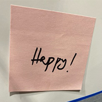 close up of sticky note that says - happy